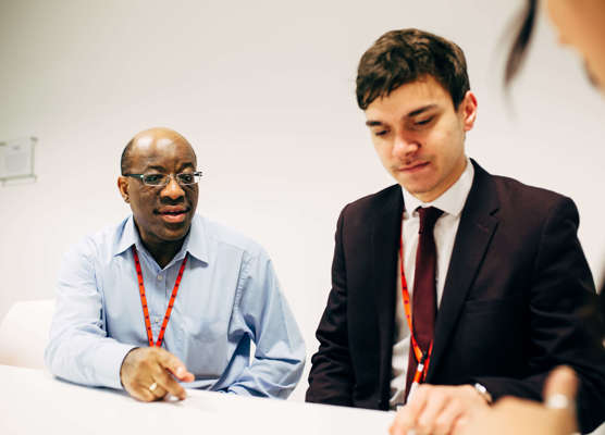 a manager and employee having a personal development meeting in the office