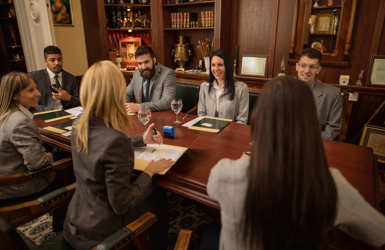Group of legal professionals discussing Lexcel accreditation in their office