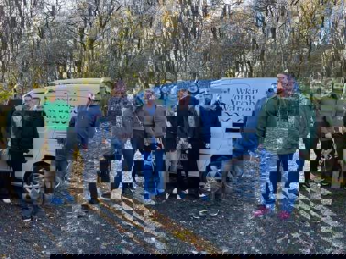 Group of volunteers stood next to a charity van